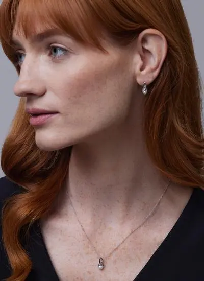 Red haired model wearing Sterling Silver Trinity Pearl Earrings and matching pendant